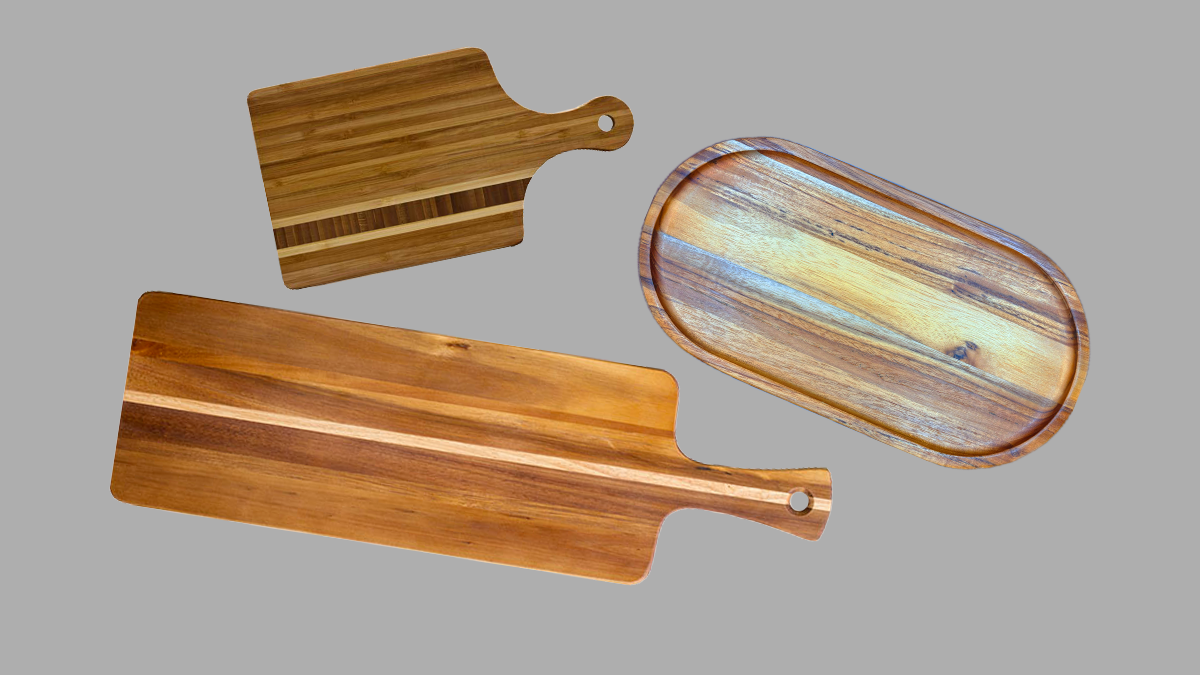 Three wooden serving boards: two paddle boards and an oval tray