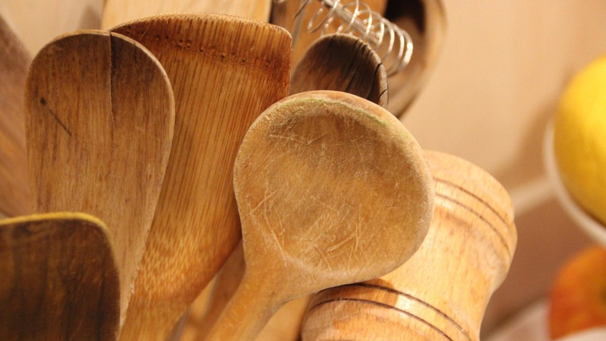 Wooden spoons and spatulas standing together in a holder